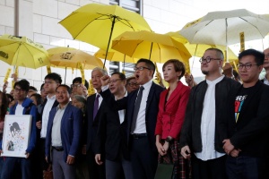 Pro-democracy activists pose outside a court in Hong Kong